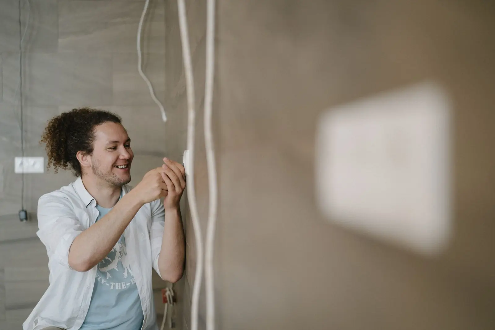 Residential electrician installing an outlet in a home